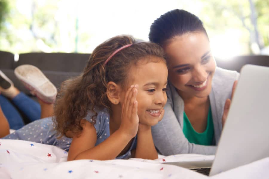 Mom and daughter looking at a laptop - Are you looking for the perfect homeschool schedule for working moms? Well, there isn't one! But I can show you how to find yours!
